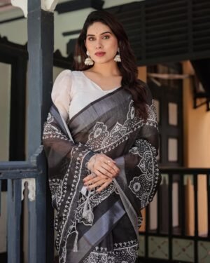 Black linen cotton saree with silver weaving patta and digital floral print by Noir and Grace