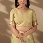 Pista green Paithani cotton saree drape and zari border detail