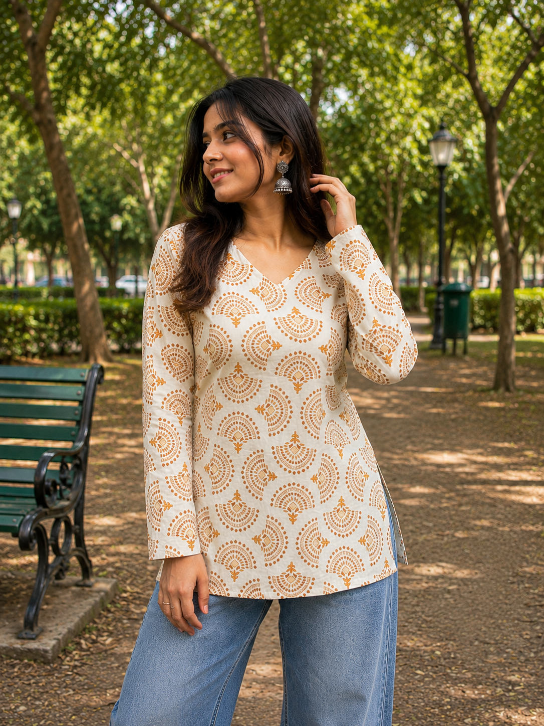 Cream Printed Cotton Short Kurti styled with jeans by Noir and Grace